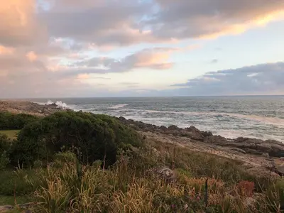 a view of the ocean from the shore of a beach at Jocks Place (on the sea) in Bettyʼs Bay