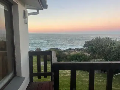 a view of the ocean from the balcony of a house at Jocks Place (on the sea) in Bettyʼs Bay