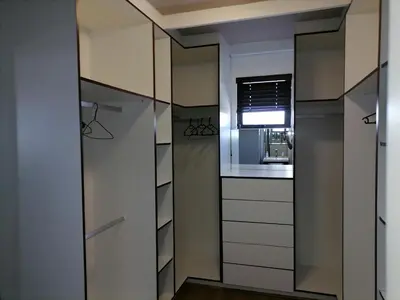 a walk in closet with white cabinets and a window at 20 On Percy in Cape Town