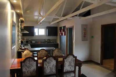 a kitchen with a table and chairs in a room at 20 On Percy in Cape Town