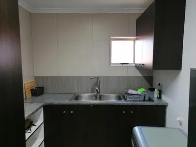 a small kitchen with a sink and a window at 20 On Percy in Cape Town