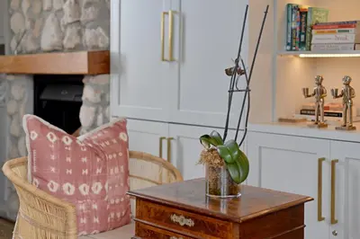 a living room with a table with a vase on it at No. 2 The Yard in Franschhoek