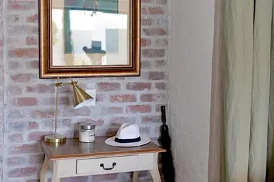 a hat sitting on top of a table in a room at No. 2 The Yard in Franschhoek