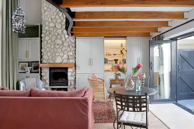 a living room with a couch and a table at No. 2 The Yard in Franschhoek