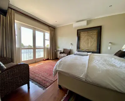a bedroom with a large bed and a large window at Mountainview Guesthouse in Cape Town