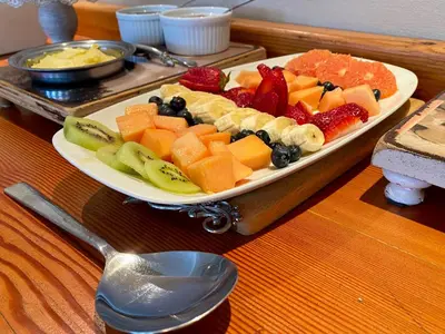 a plate of fruit on a tray on a table at Mountainview Guesthouse in Cape Town