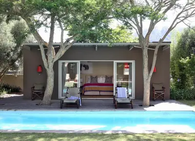 a bedroom with a bed next to a pool at The Library in Franschhoek