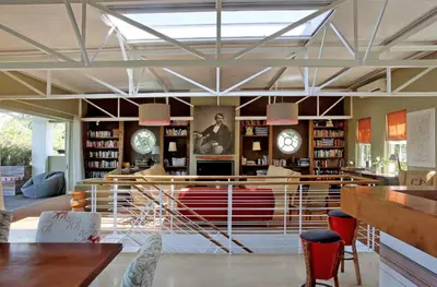 a lobby of a book store with tables and chairs at The Library in Franschhoek