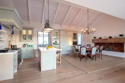 a kitchen and dining room with a table and chairs at Splendour Hermanus in Hermanus
