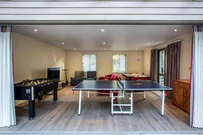a living room with a ping pong table and pool tables at Splendour Hermanus in Hermanus