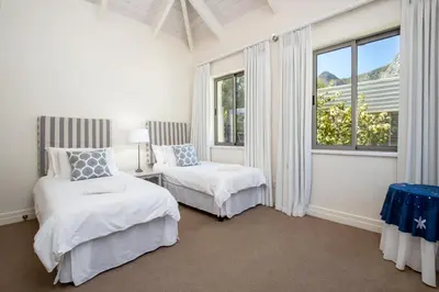 a bedroom with two beds and a window at Splendour Hermanus in Hermanus