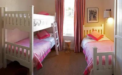 a bedroom with two bunk beds and a window at Explorers Club in Franschhoek