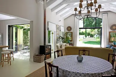 a dining room with a table and a fireplace at Tugela in Franschhoek