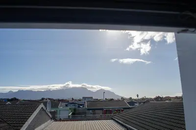 a view of snow covered mountains from a roof at Birds Holiday Accommodation 2 in Cape Town