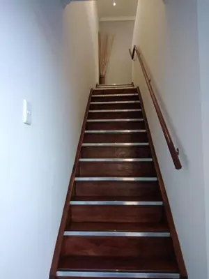 a staircase in a building with wooden steps at Birds Holiday Accommodation 2 in Cape Town