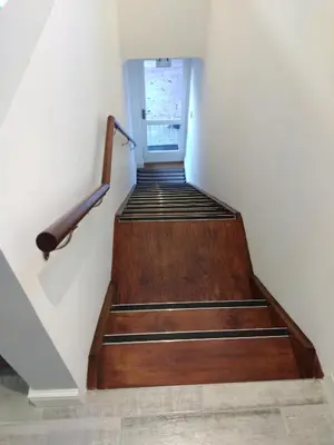 a staircase with wooden steps and a stair railing at Birds Holiday Accommodation 2 in Cape Town