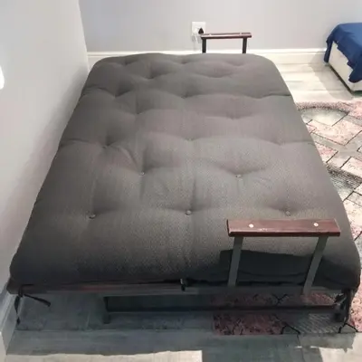 a mattress sitting in a room with a table at Birds Holiday Accommodation 2 in Cape Town