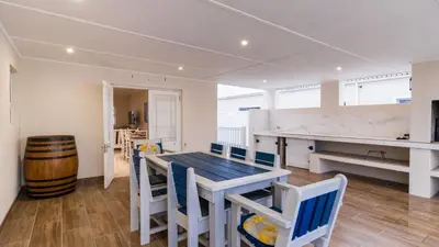 a kitchen and dining room with a table and chairs at 147 Abalone-Inn in Hermanus