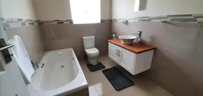 a white bathroom with a sink and a toilet at 147 Abalone-Inn in Hermanus