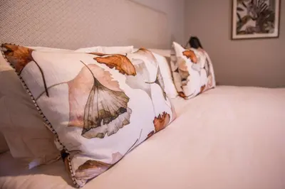 a bed with two pillows on top of it at Eikenhof Estate in Brackenfell