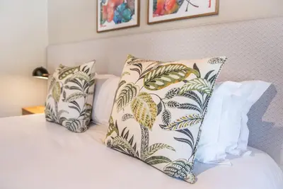 a bed with two pillows on top of it at Eikenhof Estate in Brackenfell