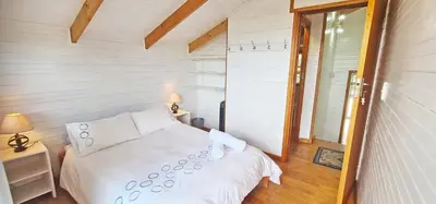 a bedroom with a white bed and a window at Little Haven 10 & 12 in Hermanus