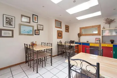 a restaurant with tables and chairs in a room at The Bohemian Guesthouse in Cape Town