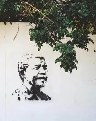 a painting of a mans head on a wall at Relaxing guest House in The heart of Ndabeni in Cape Town