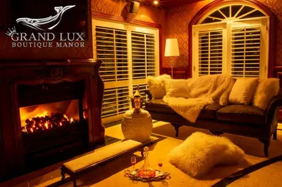 a living room with a couch and a fireplace at Grand Lux Boutique Manor in Hermanus