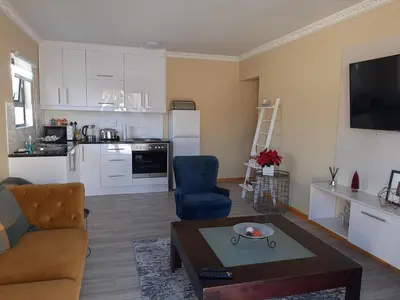 a living room with a couch and a table at Shalom Self catering in Cape Town