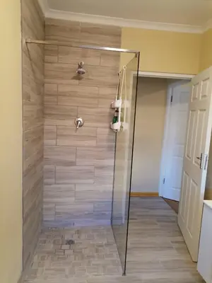 a shower with a glass door in a bathroom at Shalom Self catering in Cape Town