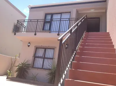 a house with stairs leading up to the front door at Sikelela Guest House in Cape Town