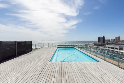 a swimming pool on the deck of a building at Horizon Bay 301 by CTHA in Bloubergstrand