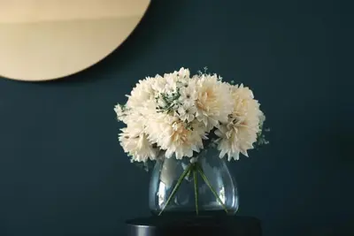 a vase filled with white flowers sitting on a table at Rose Gold @The Winchester in Cape Town
