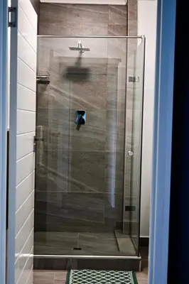 a shower with a glass door in a bathroom at Rose Gold @The Winchester in Cape Town