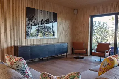 a living room with two chairs and a fireplace at Ludus Magnus Boutique Hotel in Franschhoek