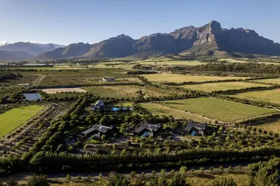 an aerial view of a estate with mountains in the background at Ludus Magnus Boutique Hotel in Franschhoek