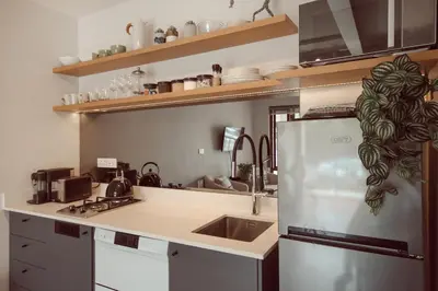 a kitchen with a sink and a refrigerator at Luxury on Dorp in Stellenbosch