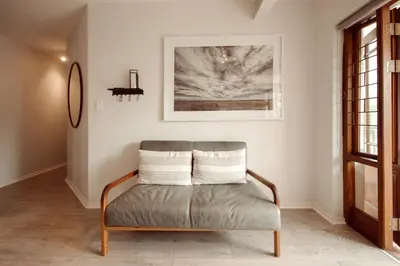 a chair in a living room with a picture on the wall at Luxury on Dorp in Stellenbosch
