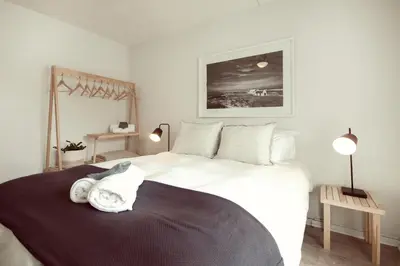 a bedroom with a large white bed with towels on it at Luxury on Dorp in Stellenbosch