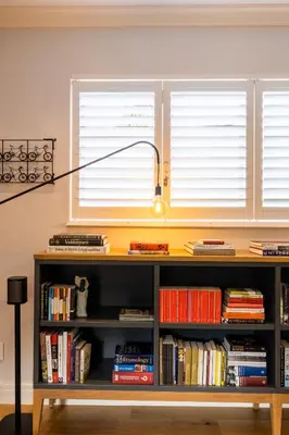 a lamp sitting on top of a book shelf at Luxury Apartments - Rozenhof Villa in Stellenbosch