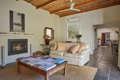 a living room with a couch and a coffee table at Tockie's Cottage in Franschhoek