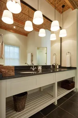 a large bathroom with a sink and a large mirror at Tockie's Cottage in Franschhoek