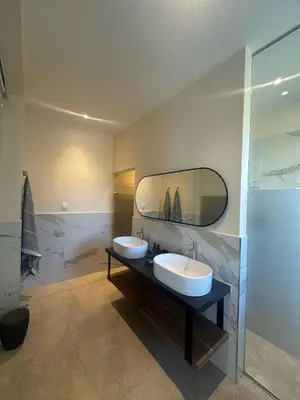 a bathroom with two sinks and a large mirror at Cape Vermeer in Somerset West