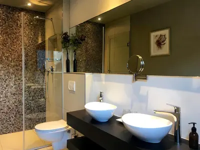 a bathroom with two white sinks and a toilet at Cape Vermeer in Somerset West