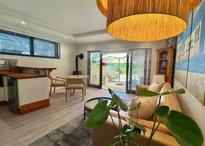 a living room with a couch and a table at The Guardian Hermanus Luxury Self-Catering Hemel en Aarde Valley in Hermanus