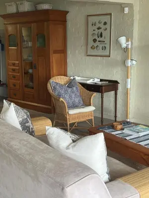 a living room with a couch and a table at By Die See in Gordonʼs Bay