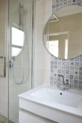 a bathroom with a sink and a mirror at By Die See in Gordonʼs Bay