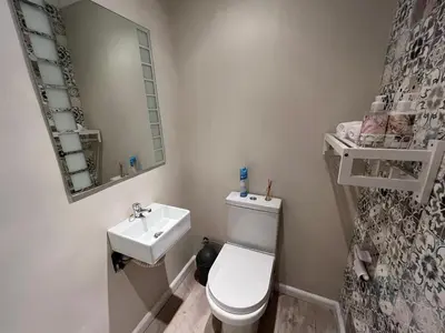 a small bathroom with a toilet and a sink at Sea front Rocky Pools in Bettyʼs Bay