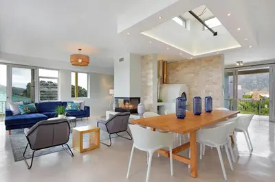 a dining room and living room with a table and chairs at Blueview on Silversand in Clareport